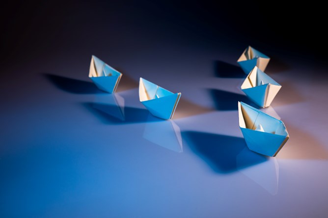 Photo of origami boats in an arrow formation